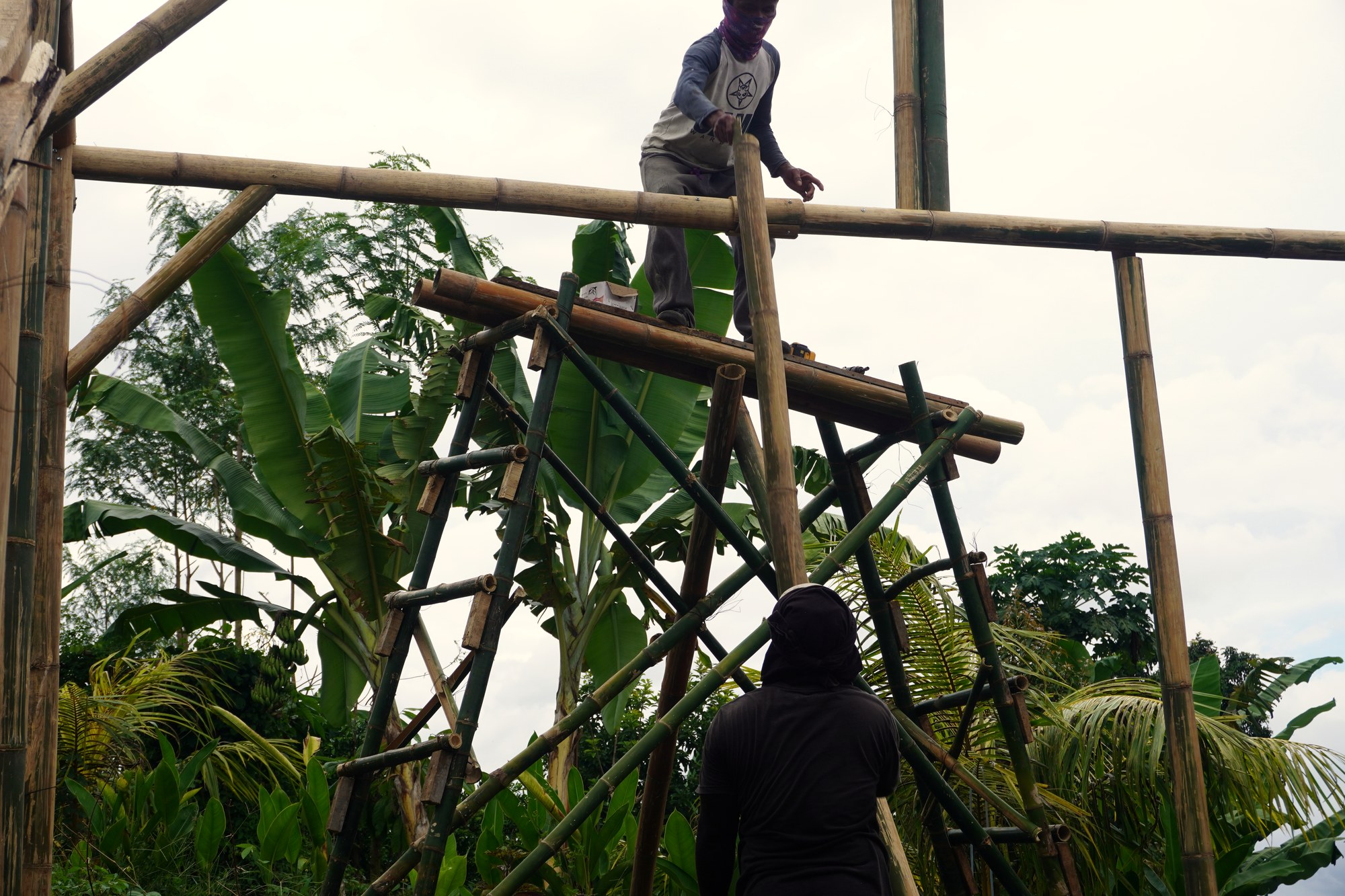 The wooden structural frame of a building under construction on the hill